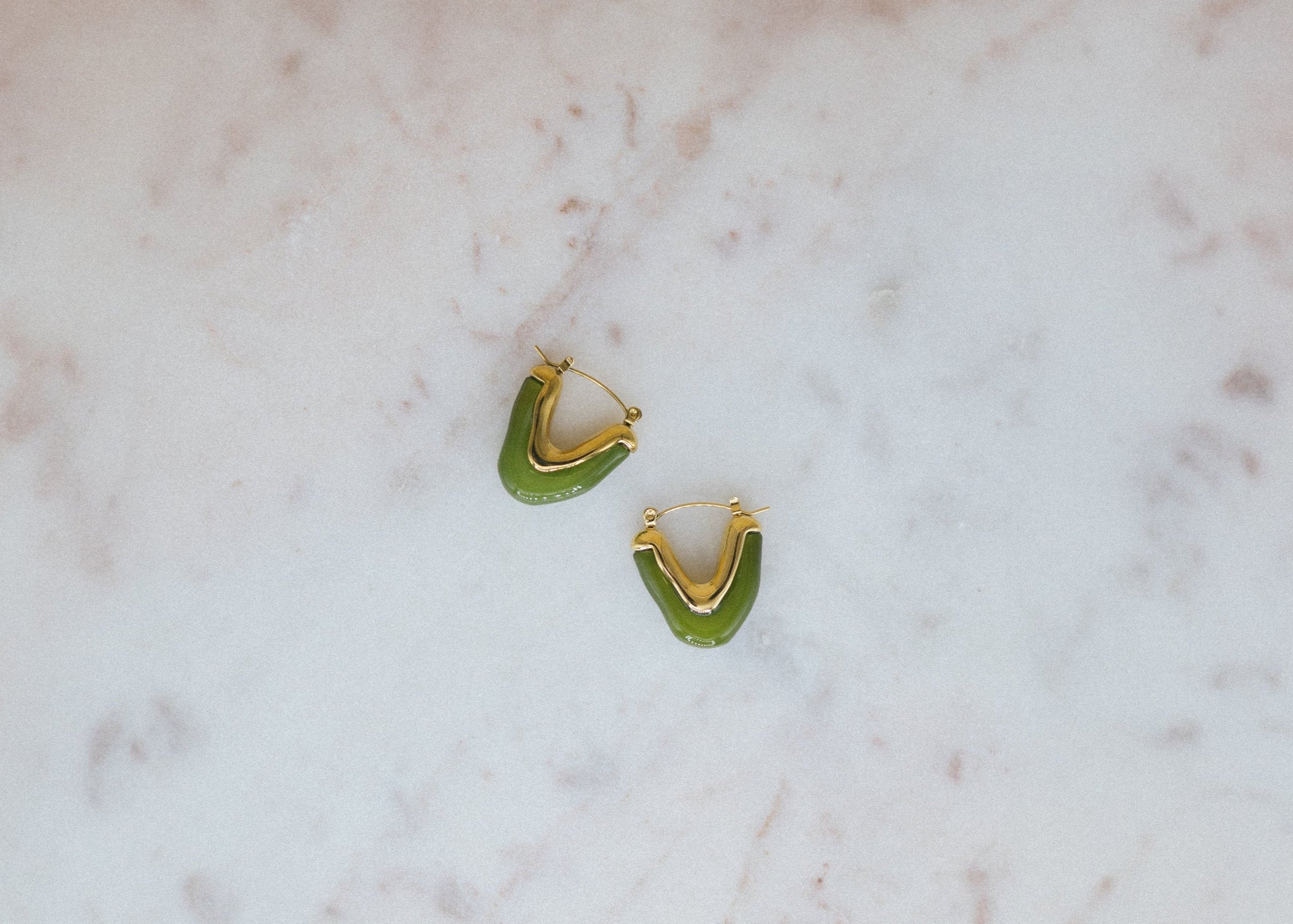 Golden Moss Hoops. Green hoop earrings on a marble surface